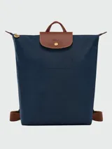 Mochila Longchamp modelo Le Pliage Original M, color crudo con detalles en cuero marrón.