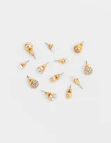 Set de seis pares de aros pasantes con cierre de tope a presión. Incluye aros con perlas, strass y metal con distintas texturas.