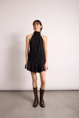 Vestido corto negro con cuello halter, espalda descubierta y doble volado en el ruedo.