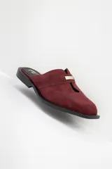 Zuecos con estampado animal print en blanco y negro, con tira ancha de cuero negro y aplique metálico.