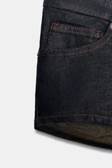 Shorts mini de denim color azul oscuro, tiro bajo, con cinco bolsillos y costuras en tono naranja.