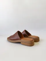 Sandalias bajas de cuero color marrón con suela de yute. Fabricadas en Uruguay.