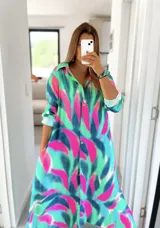 Camisola larga con cuello camisero, mangas largas y estampado abstracto en tonos verde, azul y fucsia.