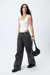 Pantalón jean ancho color gris oscuro, con elástico en la cintura y cordones ajustables en los bajos. Cuenta con grandes bolsillos laterales y traseros.