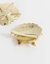 Set de dos hebillas doradas para el pelo con forma de concha marina y aplique de estrella de mar.