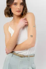 Musculosa lila de breteles finos con escote en V en el frente y espalda en U, confeccionada en tejido fluido con leve textura satinada.