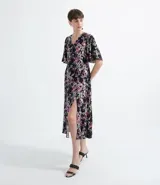 Vestido midi de crepe con estampado floral, escote en V, mangas cortas anchas y abertura frontal.