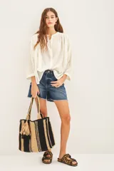 Camisa color crudo de corte amplio, tela liviana y cuello redondo con frunces en frente y espalda.