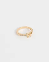 Anillo dorado con strass y un moño de metal.