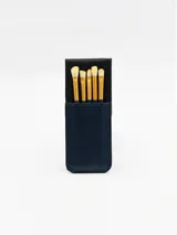 Estuche azul oscuro para guardar y transportar pinceles de maquillaje.