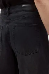 Pantalón de jean estilo barrel, color marrón oscuro con efecto desgastado. Presenta un calce holgado y tiro alto.