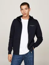 Buzo azul marino con capucha, cierre de cremallera frontal, bolsillos tipo canguro y logo de Tommy Hilfiger bordado en el pecho.