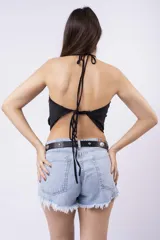 Top negro ajustado con escote drapeado tipo cowl neck y cuello halter. La tela presenta pequeños apliques brillantes distribuidos por toda la superficie.