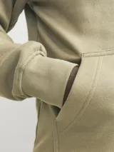 Canguro color beige con capucha, mangas largas, corte relajado y bolsillo tipo canguro. Estampado con texto "Originals Studio" en el pecho.