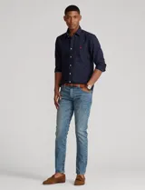 Camisa blanca de corte clásico, confeccionada en tejido oxford de algodón. Presenta cuello button-down, manga larga con puños abotonados y logo bordado en el pecho.