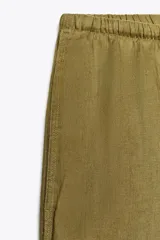 Pantalón palazzo color ladrillo confeccionado en lino 100%, de tiro medio con cintura ajustable con cordones, bolsillos laterales ocultos en costura y pierna ancha.