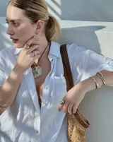 Collar con dije grande de bronce con forma de ostra y cordón de algodón ajustable color gris.