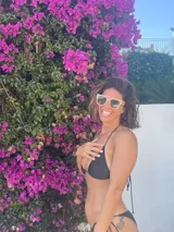 Top de bikini negro, de corte triangular y tiras finas para atar.