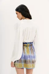 Minifalda de viscosa con estampado batik en tonos azul, violeta y amarillo. Cintura elastizada con cordón de ajuste.