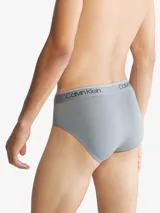 Pack de tres slips negros de algodón con cinturilla elástica con logo Calvin Klein en blanco, negro y rojo.