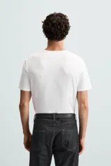 Camiseta marrón de corte slim fit, confeccionada en tejido de algodón con elasticidad, cuello redondo y manga corta.