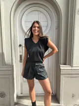 Blusa negra de lurex con hombreras y escote en V.