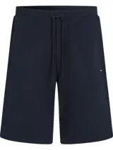 Short azul marino de felpa con cintura elástica ajustable con cordón, tres bolsillos y logo de Tommy Hilfiger bordado en el ruedo.