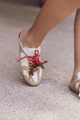 Zuecos color tostado de cuero con cordones de colores.