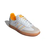 Zapatillas de cuero blanco con detalles en amarillo y suela de goma, diseño bajo.
