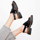 Sandalias de cuero color suela con plataforma y hebilla ajustable.