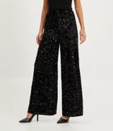 Pantalón largo de lentejuelas negras con forro, corte palazzo y cintura alta.
