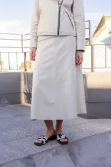 Falda midi de cuero negro, corte evasé.