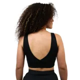 Top deportivo negro de mujer, corte crop top, con escote redondo y tirantes anchos. Presenta el logo de Diadora en blanco en el pecho.