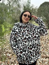 Canguro de polar con capucha y estampado animal print de leopardo en tonos blanco, negro y marrón.