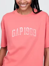Remera corta color blanco con logo de Gap estampado en el frente y mangas cortas con detalle de rayas horizontales.