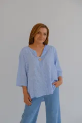 Blusa celeste a rayas verticales blancas, de corte holgado, con cuello en V y mangas 3/4.