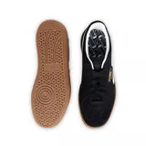 Championes Puma Palermo negros con detalles en blanco y suela color caramelo.