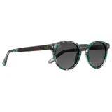 Lentes de sol redondos con montura de acetato con estampado de hojas en tonos verdes y grises. Lentes grises y patillas con el logo de la marca Indie. Hechos a mano y sustentables.