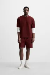 Bermuda negra de corte relaxed fit, con cintura elástica ajustable con cordón, bolsillos frontales y bolsillo trasero de parche.