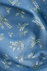 Vestido largo de lino y viscosa color celeste con estampado de flores blancas. Tiene mangas cortas abullonadas, escote corazón con tiras finas, copas preformadas con frunces, elástico en escote, hombros, mangas y cintura, cierre lateral oculto y tajo pronunciado en un lado.