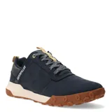 Zapatos bajos Caterpillar modelo Hex Ready Lo, color azul marino, con capellada de nobuk o cuero sintético. Suela gruesa bicolor, con entresuela color crema y suela exterior de goma marrón con diseño de hexágonos. Cordones grises con puntos blancos y detalles en amarillo claro en la lengüeta y tirador trasero.