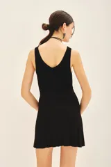 Falda mini negra de tejido de punto con cintura elastizada y diseño plisado.
