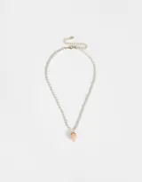 Cadena corta de perlas sintéticas color crema con dije de frutilla rosa y detalles dorados.