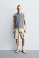 Bermuda cargo de algodón color marrón oscuro, tiro medio, corte regular, con bolsillos laterales de parche con solapa y bolsillos traseros de vivo.