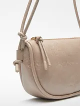 Bandolera color beige con textura craquelada, un compartimento con cierre de cremallera y bolsillo interior con cierre. Asa larga tubular y logo grabado.