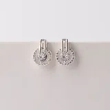 Conjunto de joyería en plata 925 con circonias, incluye collar y aros con diseño circular.