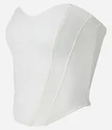 Blusa tipo corset color crema, sin breteles, confeccionada en crepé con bajo asimétrico alargado.