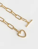 Collar corto dorado con cadena de eslabones rectangulares y dije de corazón con cierre de barra.