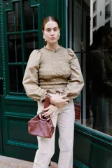 Top color beige con punto smock y mangas abullonadas.