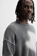 Jersey de punto gris con efecto tie-dye blanco, de corte relaxed fit, cuello redondo y mangas largas.